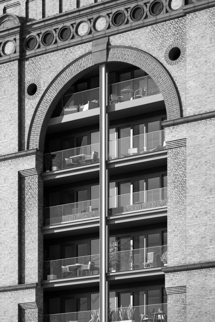 Brick arch and glazed bay — facade detail